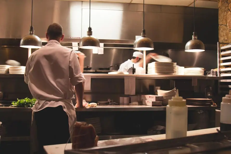 A chef working the line in a busy restaurant kitchen